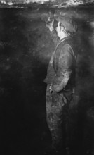 Coal Mining, Fireman searching for Gas postcard, c1900s. Creator: Unknown.