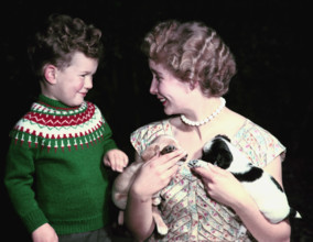 Young boy and woman holding two puppies, c1955-1965. Creator: Arthur Charles Kirby Ware.