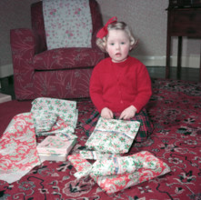 Girl opening her Christmas presents, c1955.  Creator: Arthur Charles Kirby Ware.
