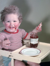 Young child eating P Hartley's Red Plum Jam and bread, c1955.  Creator: Arthur Charles Kirby Ware.