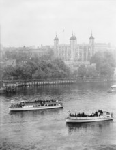 Boats passing along the Thames in front of the Tower of London, c1955. Creator: Arthur Charles Kirby Ware.