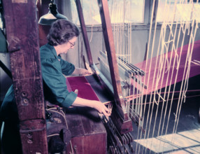 Women at a loom weaving cloth for state robes to be worn at the coronation of Elizabeth II, 1953. Creator: Arthur Charles Kirby Ware.