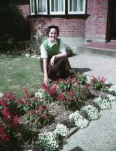 Woman proudly showing off her flower bed, c1955.  Creator: Arthur Charles Kirby Ware.