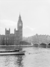 Boat passing along the Thames in front of Big Ben and the Houses of Parliament, London, c1955. Creator: Arthur Charles Kirby Ware.