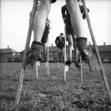 Children walking on stilts, c1955. Creator: Arthur Charles Kirby Ware.