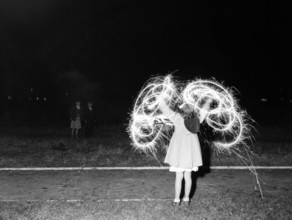 Children with fireworks, c1955. Creator: Arthur Charles Kirby Ware.