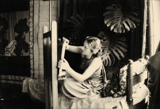 Lydia Delectorskaya preparing a canvas in Matisse’s studio, Place Charles-Félix, Nice, 1936. Creator: Matisse, Henri (1869-1954).