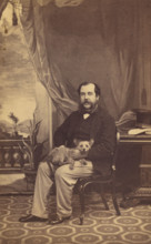 Man with Mustache and Muttonchops, seated with a dog on his lap, 1861-1864. Creator: Conway Weston Hart.
