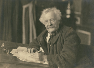 Félix Nadar seated at writing table, 1905-1910. Creator: Nadar.