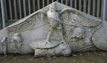 Eagle figure, armour, spear, helmet and circular shield, Roman gable, Side, Turkey, 1999. Creator: LTL.