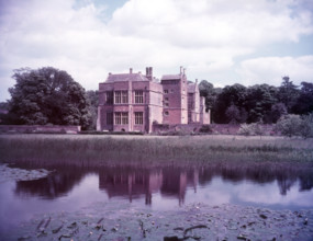 Broughton Castle and moat, Oxfordshire, c1955. [gateway, church] Creator: Arthur Charles Kirby Ware.