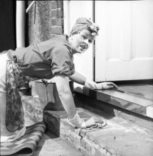 Charlady scrubbing steps, c1955. Creator: Arthur Charles Kirby Ware.
