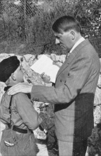 Hitler supporting a recruit from the Hitler Youth, 1936