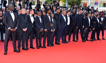 Ladj Ly, Damien Bonnard with the crew of the film 'Les Misérables'