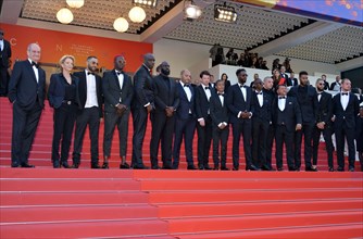 Ladj Ly, Damien Bonnard with the crew of the film 'Les Misérables'