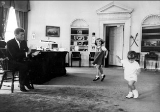 John F. Kennedy and his children in his office at the White House.