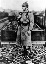 Un soldat français monte la garde près d'un train de charbon réquisitionné aux allemands