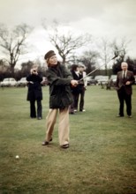 Rita HAYWORTH and Russel HARTY playing golf