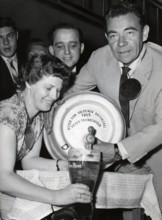 Peter FRANKENFELD taps beer from a beer keg, 1959