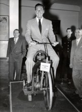 Errol FLYNN on a Daimler two-wheeler from 1885