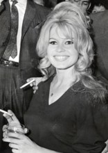 Brigitte BARDOT, portrait with cigarette and drinking glass
