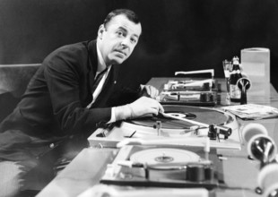 Chris HOWLAND in front of record players, undated