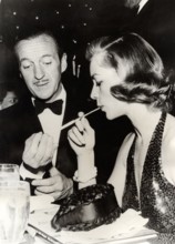 David NIVEN and Lauren BACALL at a party