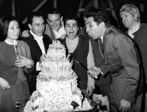 Gilbert BÉCAUD with birthday cake, Paris 1962