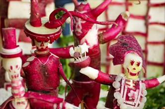 Two holidays combine: radishes are carved into figures celebrating Dia de los Muertos for a tableau at Oaxaca's Noche de Rabanos