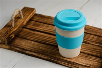 Bring your own cup. Reusable eco friendly bamboo cup for take away on wooden tray. Zero waste.