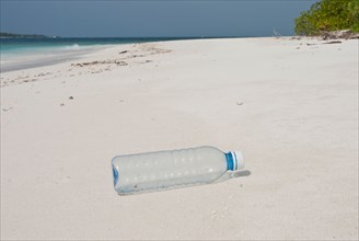 Plastic bottle washed up on a tropical beach in the Maldives.