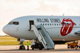 England, Manston airport. Rock and roll band, the Rolling stones Boeing 767, with lips and tongue logo on side in red, parked on apron with airstair.