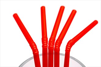 Plastic straws in a glass, UK.