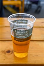 A recyclable compostable I am Not Plastic beer pint glass which is environmentally friendly