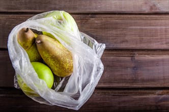 concept plasic free fruit in a plastic bag on brown background with copy space
