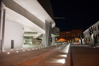 The unfinished forecourt of the new MAXXI Museum Rome designed by architect Zaha Hadid due to open 2010 at night