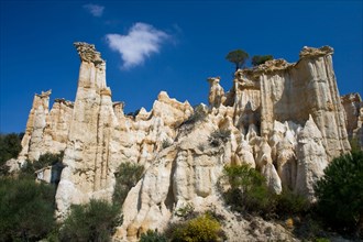 Natural chimneys made up of columns of soft rock, eroded by rain in Ille sur Tet, Languedoc Roussillon, France.