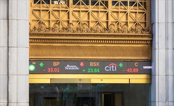 Entrance to New York Stock Exchange at 11 Wall Street, showing digital ticker tape display