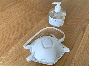 covid or coronavirus prevention kit with ffp2 mask and hand sanitizer gel bottle