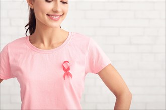 Girl Posing In T-Shirt With Cancer Ribbon On White Background