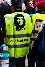 Marseille, France - January 25, 2020: A protester wearing a yellow vest during a 'marche de la colère' ('the march of anger') concerning housing issue