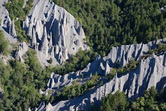 HOODOOS IN A FOREST (aerial view). Théus, Hautes-Alpes, France.