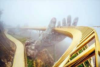 Danang , Vietnam. View in Fog of the Golden Bridge on Ba Na Hills in Da Nang on rainy day.