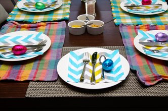 An Easter table with colourful pastel place settings.