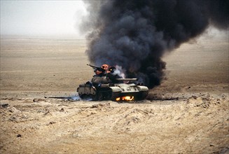 An Iraqi T-55 main battle tank burns after an attack by the 1st United Kingdom Armored Division during Operation Desert Storm February 28, 1991 in Kuwait.