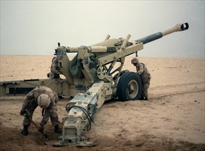 Marine artillerymen set up their M-198 155mm howitzer for a fire mission against Iraqi positions during Operation Desert Storm. U.S. Marines in the Persian Gulf War (1991) 001