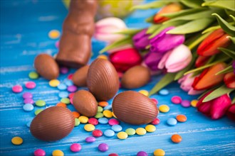 Easter chocolate rabbit,  eggs and tulips. Spring theme.