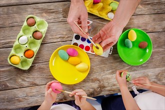 Easter. A happy family will paint eggs and get ready for Easter. Top view of the table with paints and eggs.