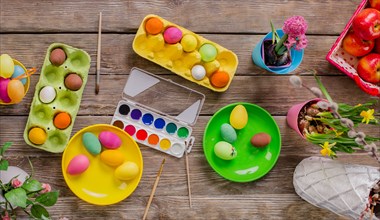 Easter. A happy family will paint eggs and get ready for Easter. Top view of the table with paints and eggs.