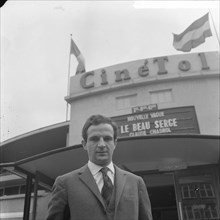 French director Francois Truffaut for cinema Cinétol, where his film plays [Le Peau Douce?] during Nouvelle Vague festival [on billboard film by Claude Chabrol Le Beau Serge] Date: 15 March 1965 Locat...